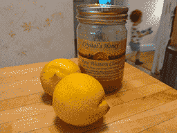 two lemons and a jar of raw clover honey